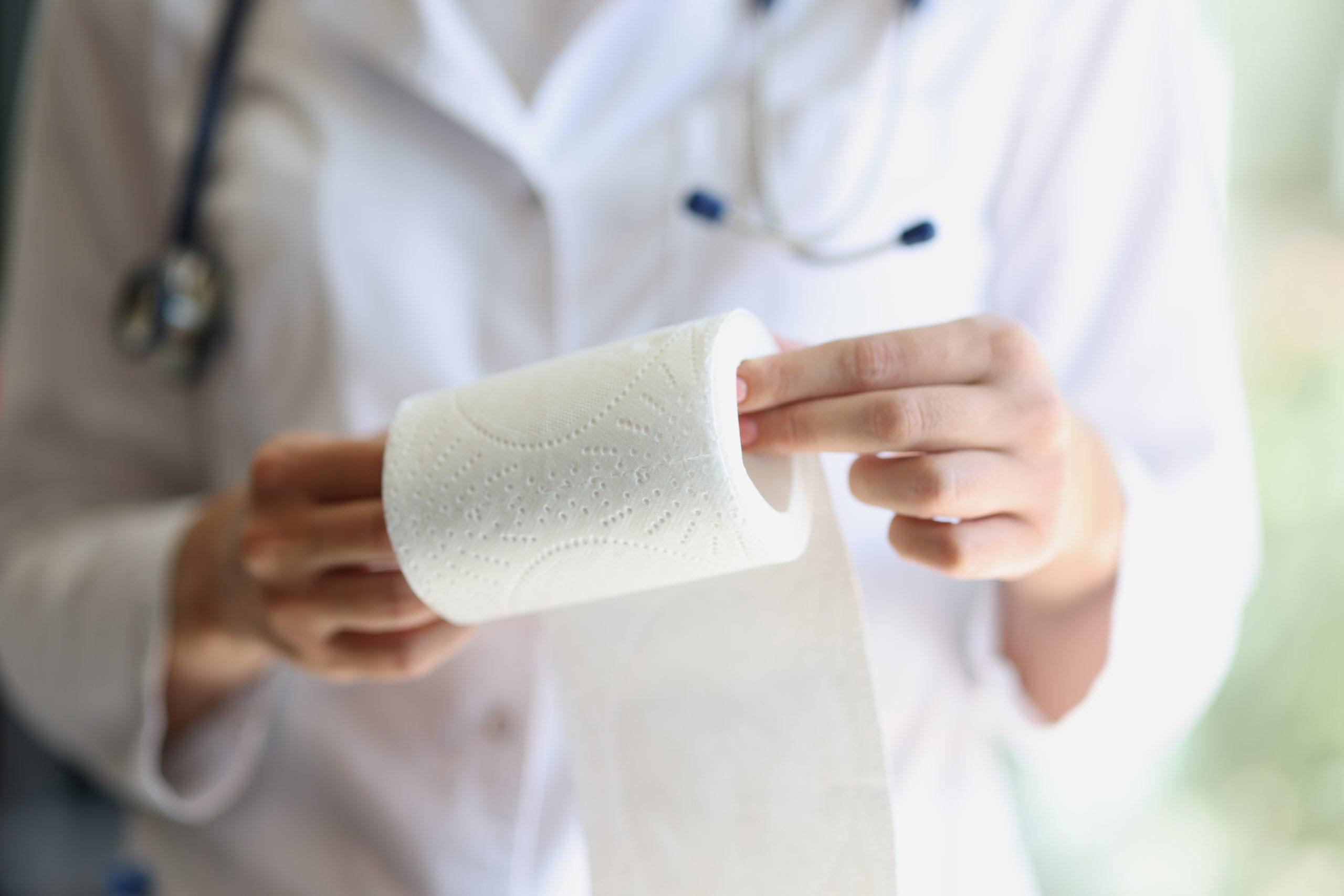 Doctor holding a toilet paper