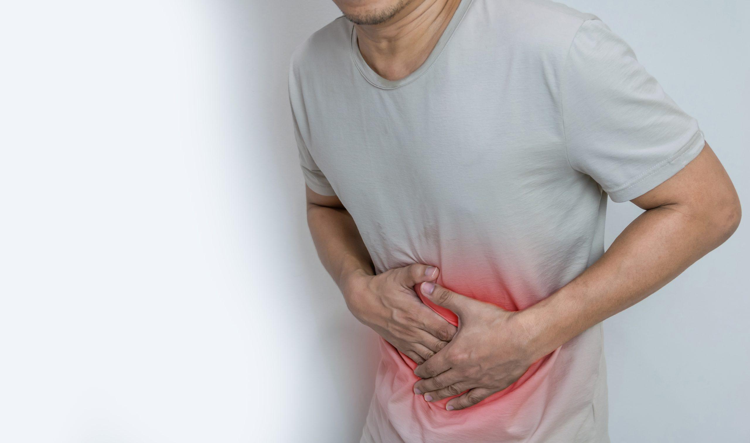 Man holding stomach due to blood in stool in Hyderabad