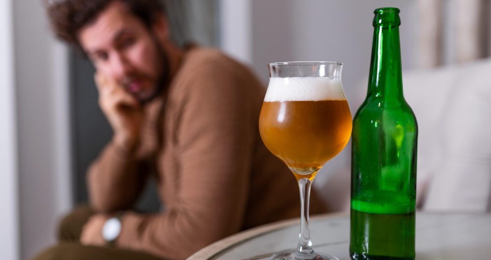 Man contemplates alcohol consumption