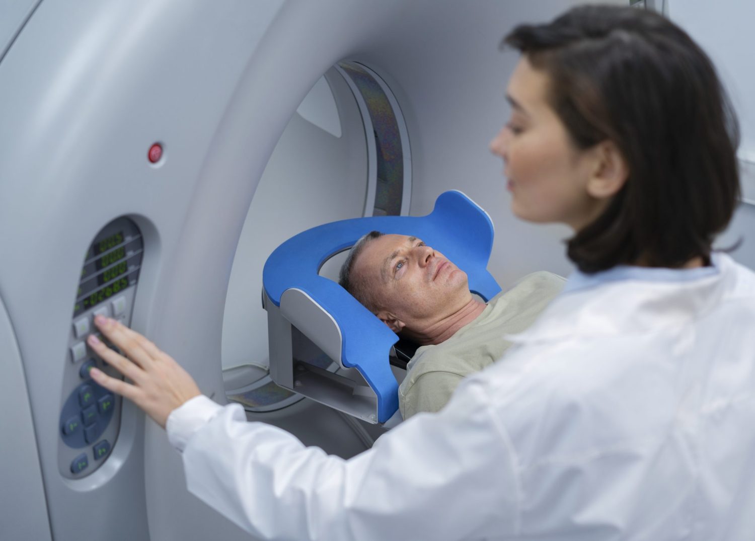 Lady doctor getting a man ready for a CT scan